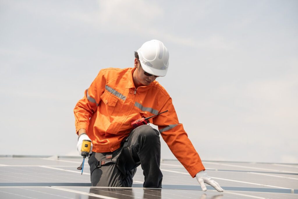 engineer checking solar cell panel on the roof of the factory.jpg