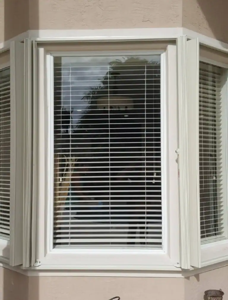Accordion hurricane shutters installed on residential window in Florida
