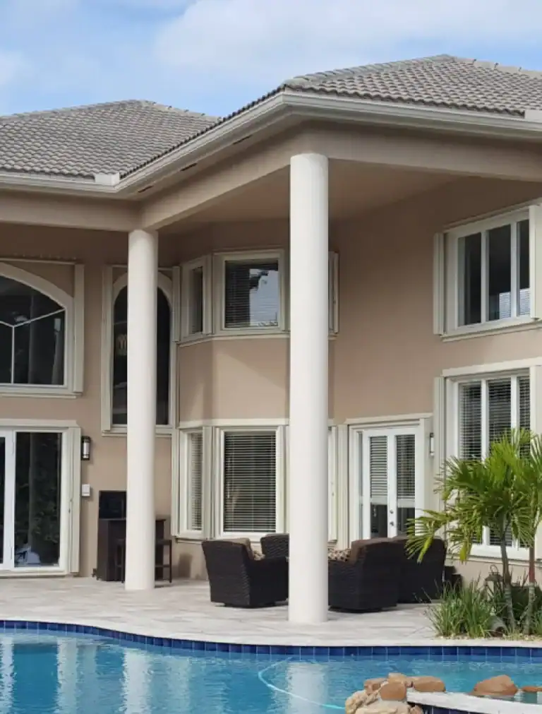 Accordion hurricane shutters installed on luxury poolside residence
