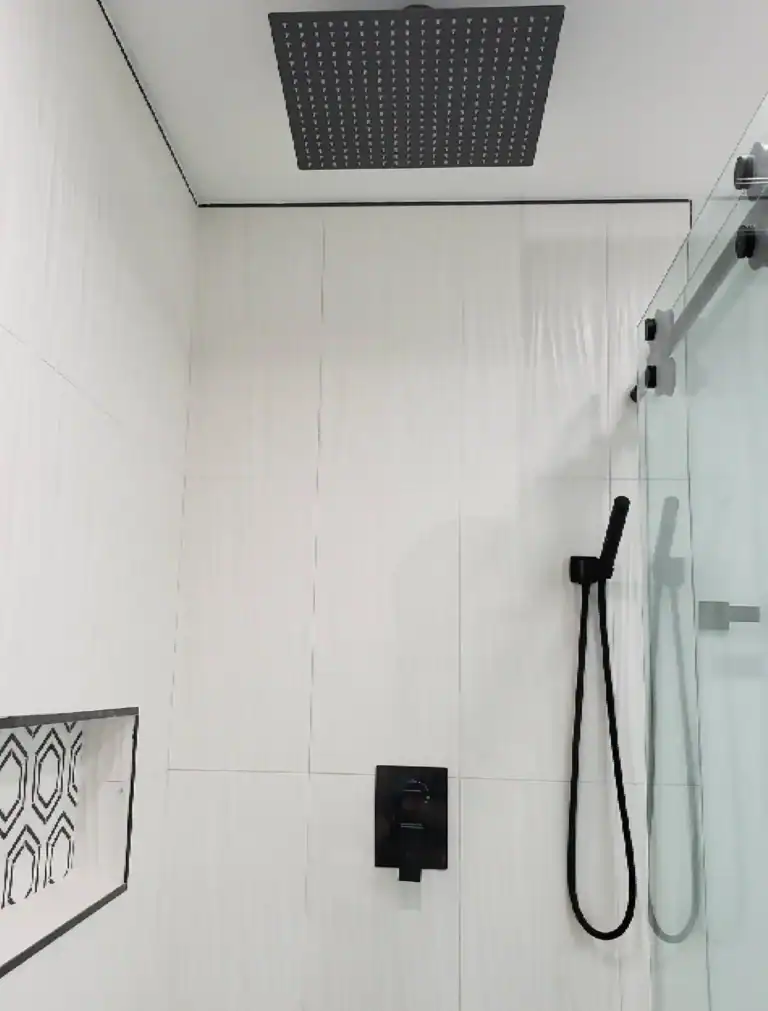 Luxury walk-in shower bathroom renovation with matte black fixtures and glass enclosure
