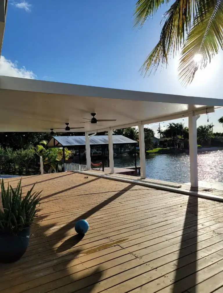 Waterfront aluminum patio cover creating shaded outdoor living space