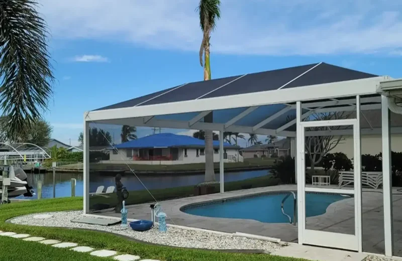 White aluminum screen enclosure covering backyard pool in Florida